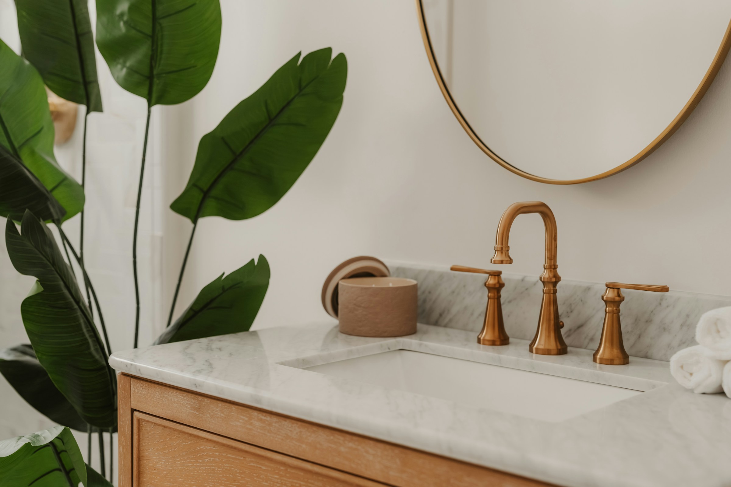 A bright bathroom with brass fixtures